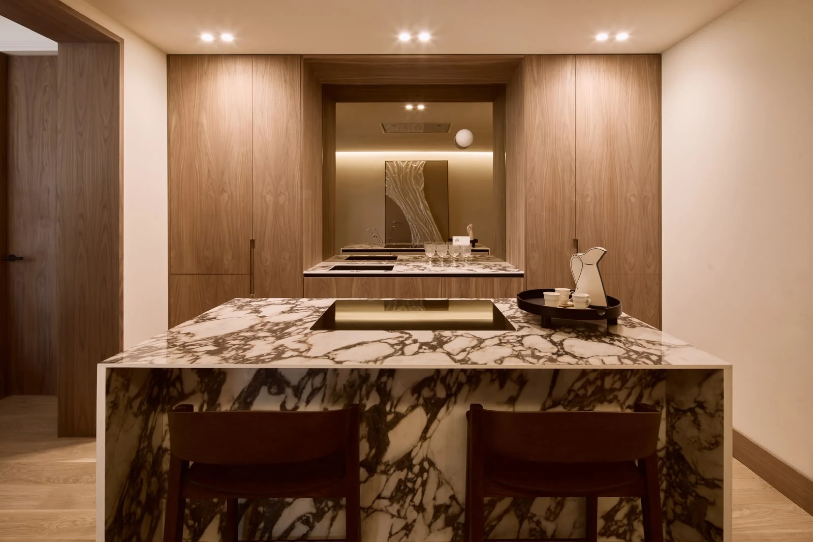 Front view of the kitchen island and walnut cupboards
