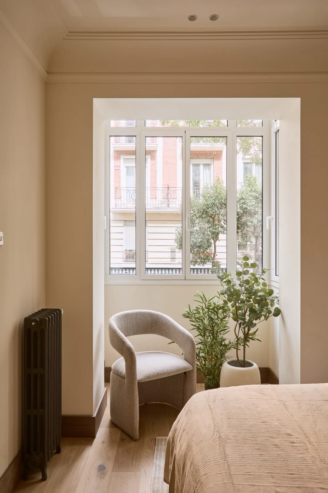 Bay-window corner with armchair, plant and radiator