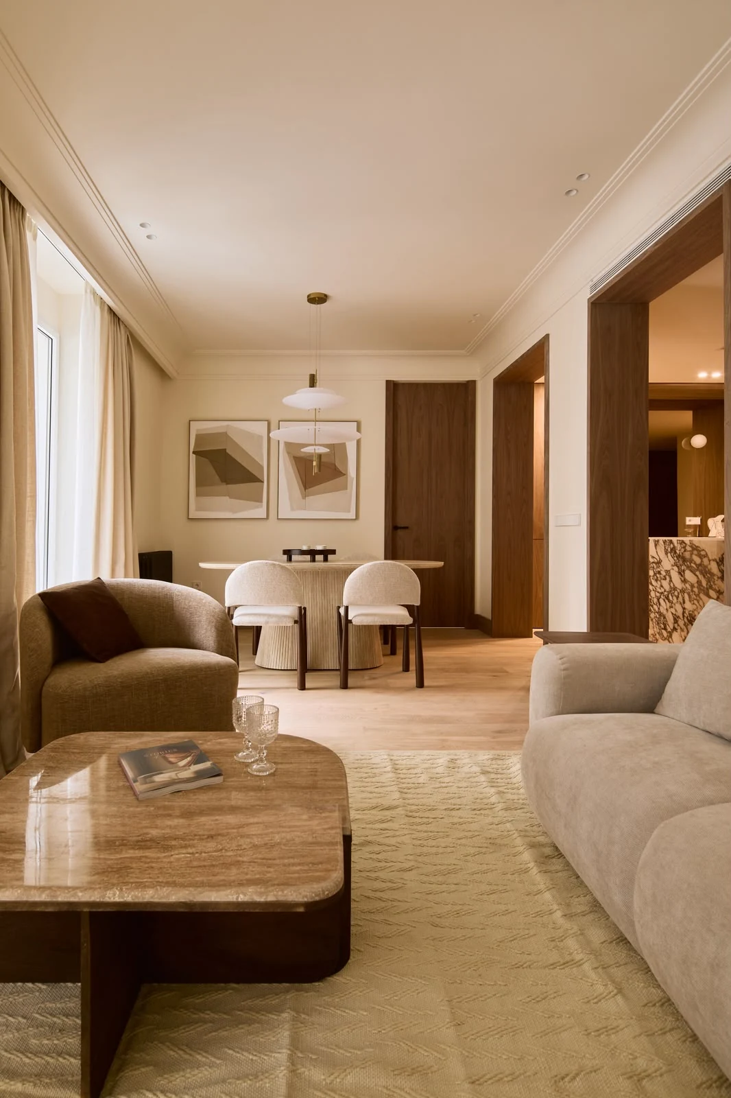 Living and dining room with marble coffee table and open-plan kitchen