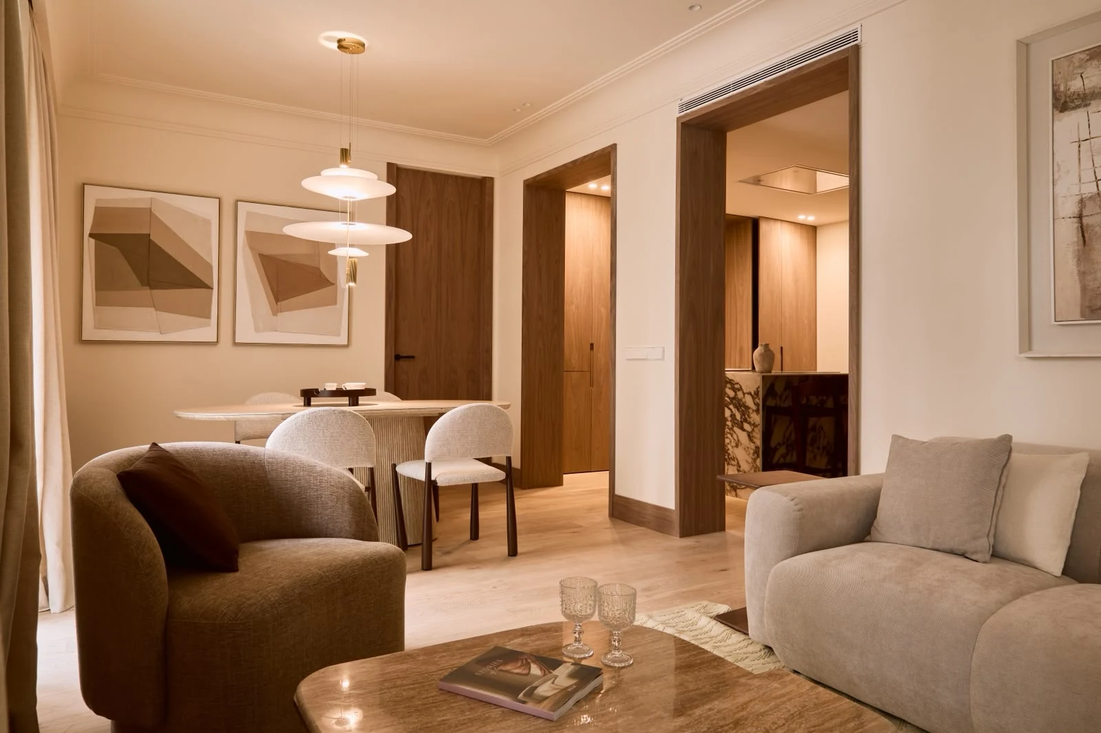 Sitting and dining areas with framed artwork and walnut doors