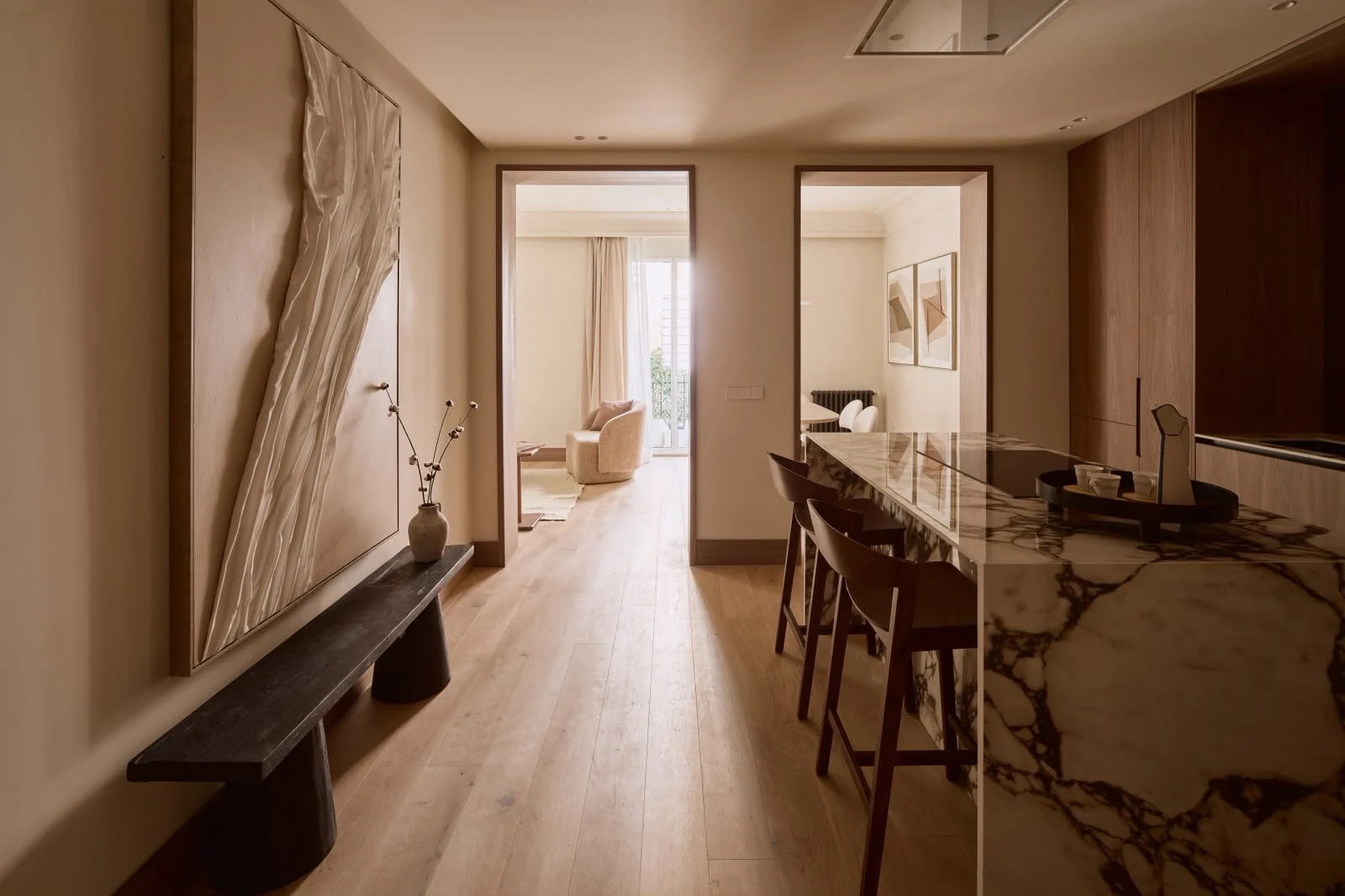 Kitchen with island and stools viewed from the entrance