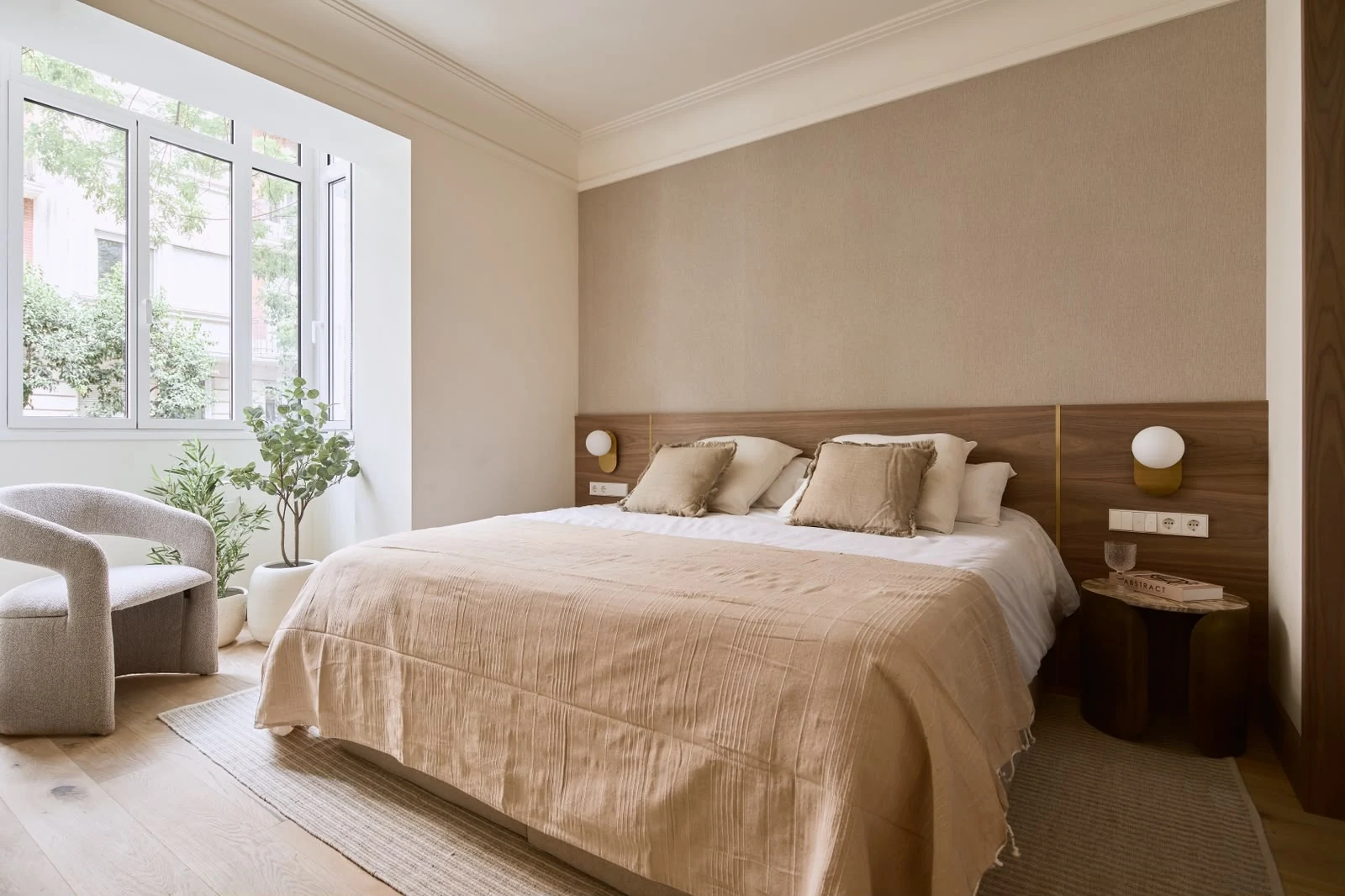 Furnished principal bedroom with a street-facing bay window